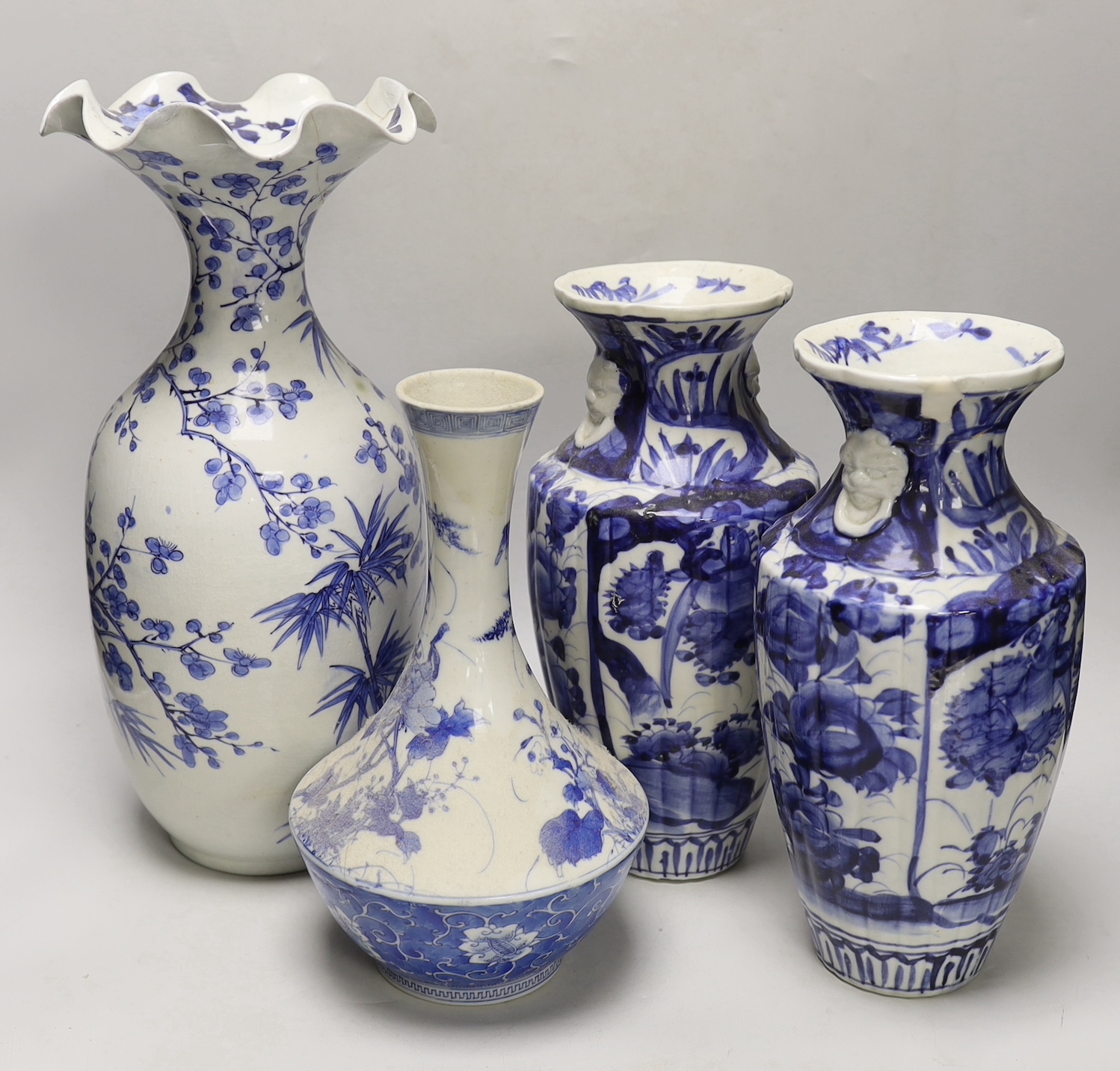 A pair of Japanese blue and white birds and flowers pattern vases and two other vases, tallest 39cm high
